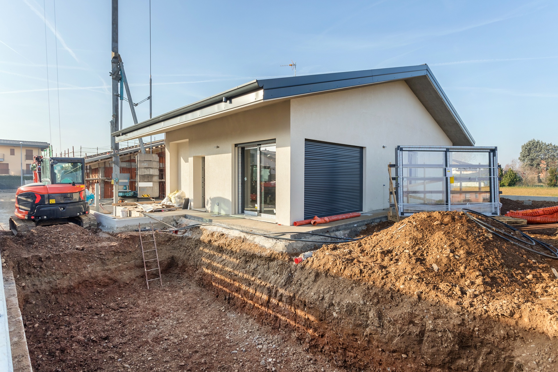 Neubau mit Baugrube und Maschine | Pool Shop